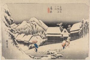  "Kanbara: Night Snow" by Utagawa Hiroshige, a traditional Japanese woodblock print depicting a snowy night in a mountain village with two figures navigating the snow-clad landscape, one dressed in blue and the other in reddish-brown, all against a background of muted blue and white mountains and gray thatched-roof houses.