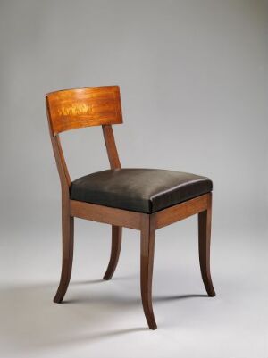  An elegantly crafted wooden chair with a glossy finish, featuring a straight back with a light-colored inlay design and a dark upholstered seat, set against a neutral background. The artist name and title are unknown.