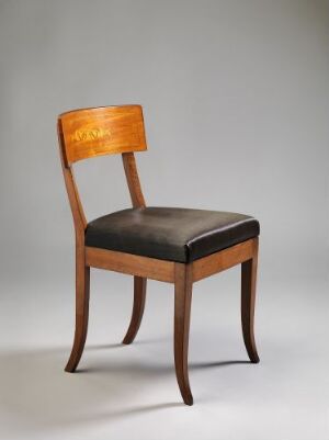  An elegant Art Deco style chair with a polished wooden frame featuring a tiger maple grain on the backrest and a dark, possibly leather, upholstered seat, set against a gradient gray backdrop.