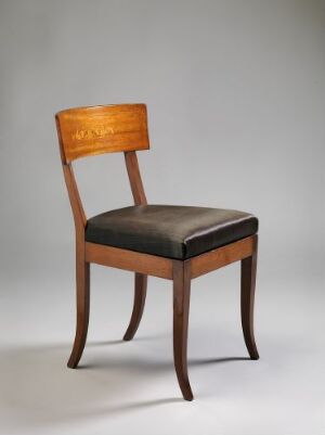  An elegant antique chair with curvaceous legs and a wooden frame in a warm reddish-brown tone, featuring a cushioned dark-colored seat and a decorative inlaid pattern on the upper panel of the backrest, set against a light grey background.