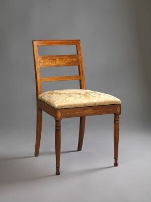  An elegant wooden chair with a ladder-back design and a cushioned, fabric-upholstered seat set against a gray background.