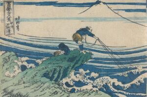  "Kajikazawa in Kai Province" by Katsushika Hokusai, a color woodblock print showing two figures fishing from a rocky outcrop, with dynamic blue and white waves in the foreground and pale blue sky in the background.