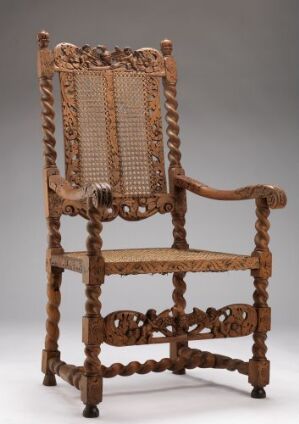  An intricately crafted walnut wood armchair titled "Stol" by an unidentified architect, featuring turned components, openwork carvings, rattan woven seat and backrest, with oak details. The chair's colors range from light to deep brown with a natural rattan hue.