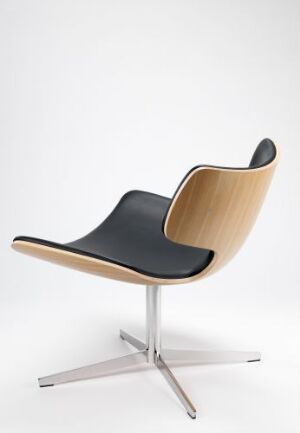  A modern chair titled "Bone" by Steinar Hindenes, featuring a varnished oak veneer seat and back with a black leather seating surface, supported by a shiny chromed steel base with four legs.