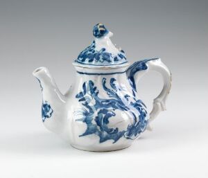  A white porcelain teapot with traditional cobalt blue floral patterns, featuring a rounded body, an elegant curved handle, and a decorative lid with a rounded knob.