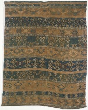  A detailed woven textile featuring horizontal bands with earth-toned geometric and floral patterns in tan, navy blue, and dark olive, separated by neutral sandy areas, potentially a historical rug or tapestry with a fringe on the edges. Artist name and title are unknown.