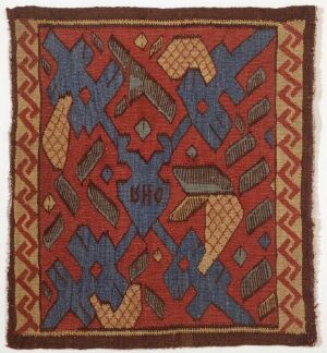  An antique square textile with a symmetrical pattern. The deep red background contrasts with the cerulean blue, beige, slate gray, and golden yellow geometric shapes. A blue and yellow zigzag border frames the central diamond-like design, surrounded by an outer edge with a beige herringbone pattern. The textile shows signs of wear and age.