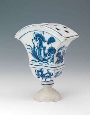  An ornate blue and white porcelain vase with a peacock design, set against a neutral gray background.