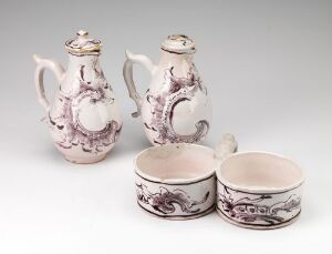  A set of white-glazed faience pottery with hand-painted manganrødt decorations, consisting of two pitchers and two bowls, showcasing intricate swirling patterns and floral motifs. Artist: Unknown.