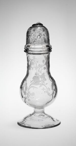  A vintage-style clear glass salt shaker with a finely textured cap and detailed pattern embossed on the body, photographed in grayscale against a light background.