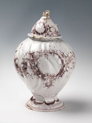  An elegant white-glazed faience lidded vase with hand-painted manganese red floral and vine motifs, with artist name unknown and no title.