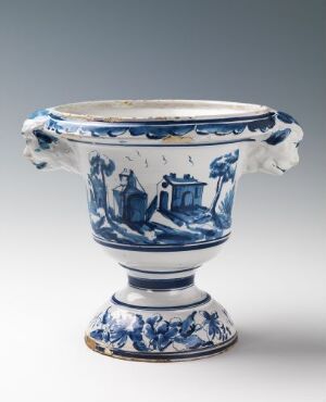  Decorative earthenware piece with white glaze and hand-painted cobalt blue pastoral scenes, attributed to Herrebøe Fajansefabrikk, featuring a footed bowl shape with scalloped edges and ornamental relief.