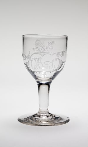 
 A clear glass goblet with embossed design details, set against a light gray background.