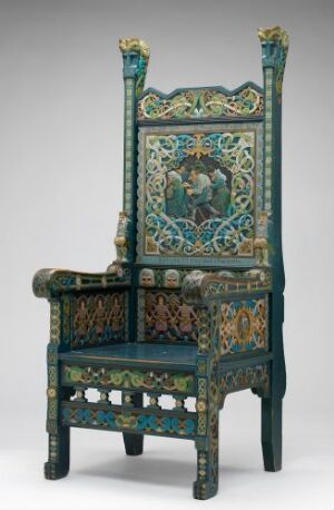  An elaborately decorated chair with a high backrest, featuring a central panel with a figurative scene and surrounded by intricate floral and geometric patterns in teal, green, red, and gold.