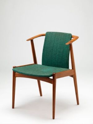  Nestor chair by Torbjørn Afdal, featuring an oil-treated teak frame with medium-brown tones and a seat and back upholstered in rich green wool, exemplifying mid-century modern design.