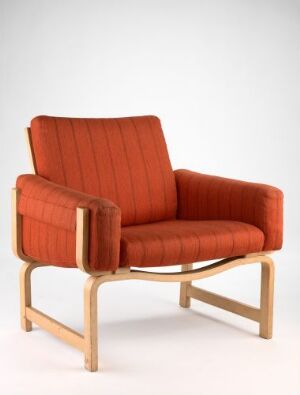 
 "Laminat" chair by Sven Ivar Dysthe, a mid-century modern design with a laminated oak frame showing pale to honey gold colors and a seat, back, and armrests padded with skumgummi and upholstered in rich rusty orange wool.