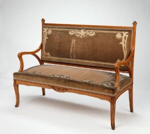  An antique wooden settee with a darker mahogany frame and lighter inlaid backrest panel featuring ornate botanical motifs. The elegant curved arms and legs suggest a 19th or early 20th-century origin, against a neutral backdrop.