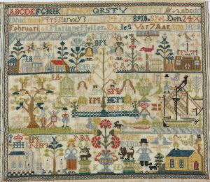  An embroidery sampler with rows of alphabet letters and various scenes depicting birds, plants, human figures, and buildings, rendered in muted earth tones on a light beige fabric.