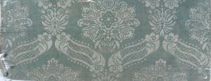  A greenish-gray fabric or wallpaper with a silver-green intricate floral and swirling pattern, depicting a sense of classic elegance without any discernible artist's name or title.