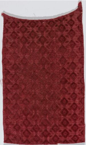  A tall vertical image of a rich dark red woven textile with a consistent diamond-shaped pattern and subtle variations in red tones that give the fabric a textured appearance.