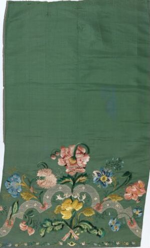  A fabric with a rich forest green background featuring a hand-painted or printed floral design at the bottom, with a prominent yellow flower in the center surrounded by various pink, blue, and white flowers and detailed green leaves.