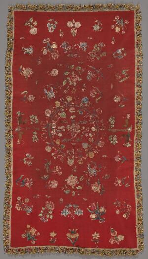  Antique textile with a deep red background featuring a dense pattern of stylized flowers in gold, green, and white, framed by an intricate gold border with classical motifs.