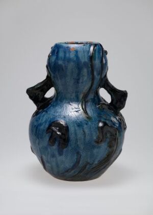  A ceramic vase with a globular body and narrow neck, featuring a gradient of deep to light blue glaze and four rounded protrusions around its widest part.