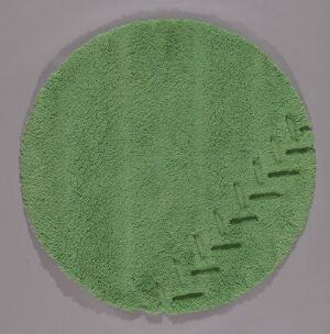  A circular hand-tufted textile art piece by Eivind Holseth, in a light green color, with raised tufts forming abstract shapes along the edge. The piece has a consistent, monochromatic green tone and a fluffy texture suggestive of soft grass or moss.