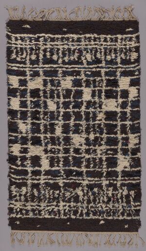  "Småstad" by Anita Markelius, a handwoven textile piece with a dark background featuring a grid of abstract, light-colored patterns resembling an urban landscape. The texture is rich with contrasting wool and linen yarns.