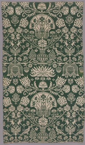  A detailed, symmetrical floral and ornamental pattern textile piece predominantly in emerald green with cream or off-white accents, suggesting a luxurious fabric possibly of historical or cultural significance. Artist name and title are unknown.