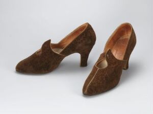  A pair of vintage-style women's high-heeled shoes in a rich brown suede material, displayed against a light grey background.