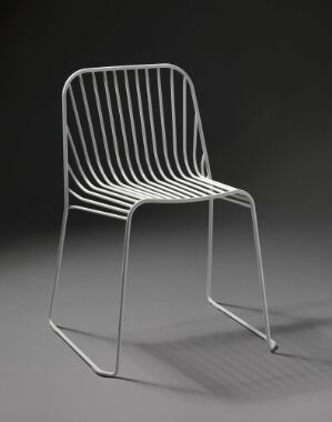 
 "Spline" by Norway Says, a minimalistic white chair made of form-bent plastic-coated steel with a series of vertical bars creating the seat and backrest, set against a gray background.