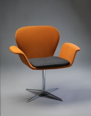  A modern chair with burnt orange wool upholstery over foam padding on the seat, backrest, and armrests, featuring a bent plywood base and a star-shaped steel foot, demonstrating a mid-century modern design with no specified title or artist.