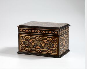  An intricately inlaid, dark wooden box with lighter-colored top, featuring detailed patterns in ivory and reddish-brown colors, standing on a plain gray background.