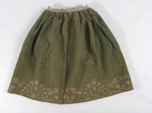  Vintage olive green full skirt with a floral pattern around the hem, laid flat against a light background.