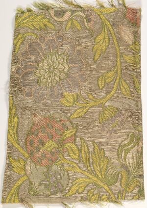  Vintage fabric or wallpaper with a botanical print, featuring interwoven green leaves, a large yellow flower, and a red patterned fruit motif against a textured beige background.