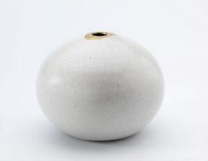  A white spherical ceramic or porcelain vase with a gold-rimmed opening at the top, placed against a light gray background.