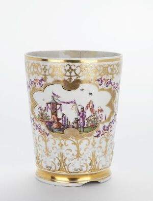 
 An ornate cylindrical ceramic cup with gilded gold rims and a central scene in muted purple and brown tones depicting an oriental landscape, surrounded by detailed floral and scroll motifs, set against a white background.