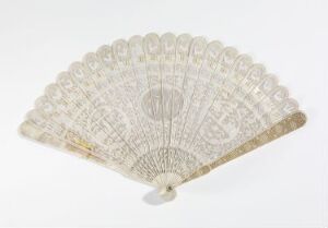  An open, creamy white lace folding fan with intricate symmetrical patterns and a round central medallion, displayed against a light background.