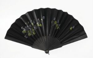  An open black fan with a delicate floral pattern in shades of green, lilac, purple, and blue painted on it, set against a white background.