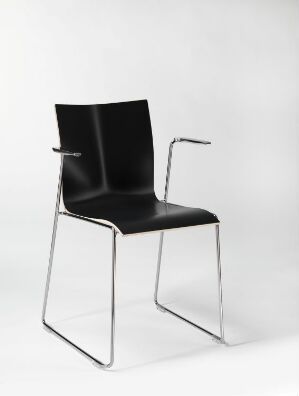  A modern chair by Engelbrechts featuring a laminated, form-bent plywood seat and backrest in black, with polished steel arms and legs. The design combines sleek lines with a minimalist aesthetic and reflects a contemporary ethos in furniture design.