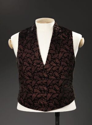  A sophisticated brown leaf-patterned waistcoat displayed on an off-white torso mannequin against a gradient gray background.