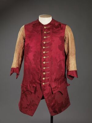  Antique red damask-patterned waistcoat with golden buttons and attached pale yellow sleeves displayed on a mannequin against a gray background.