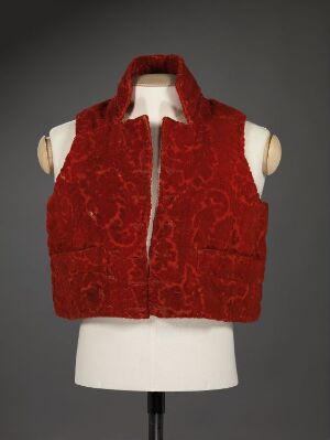  A richly embossed red sleeveless vest displayed on a white torso mannequin against a gray background.