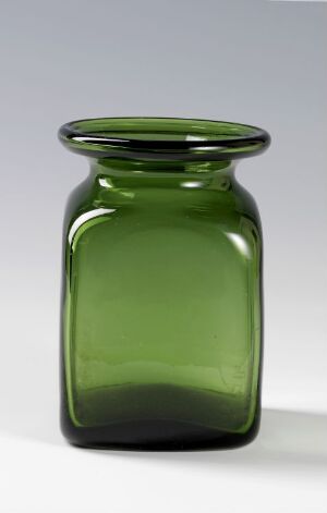  A deep green glass jar with a flared opening and rounded base against a light gray background.