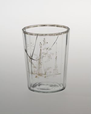  A clear glass tumbler with delicate metallic golden-bronze botanical inclusions against a light grey background.