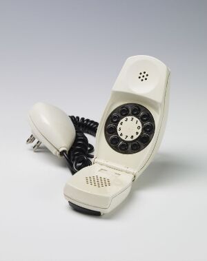  A vintage off-white Siemens AG rotary dial telephone with a black coiled cord, displayed against a light background, evoking a mid-20th-century design aesthetic.