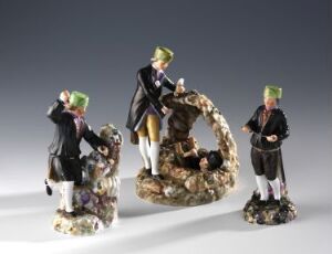  A set of three intricately painted porcelain figurines from potentially the 18th or 19th century, depicting people dressed in traditional European clothing with green tricorn hats, engaged in social scenes on a plain white surface with a neutral background.