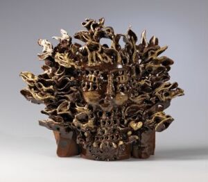  "Solvind" by Hertha Hillfon, an abstract glazed ceramic sculpture with a multitude of twisted and curled elements in earthy brown tones radiating from a central, pot-like base, mimicking organic forms.