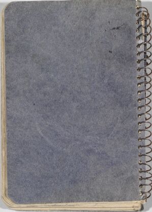  A well-used, spiral-bound sketchbook titled "Skissebok" with a muted blue-gray cover showing signs of wear. The edges appear frequently handled, and the metal spiral binding is visible on the left side.